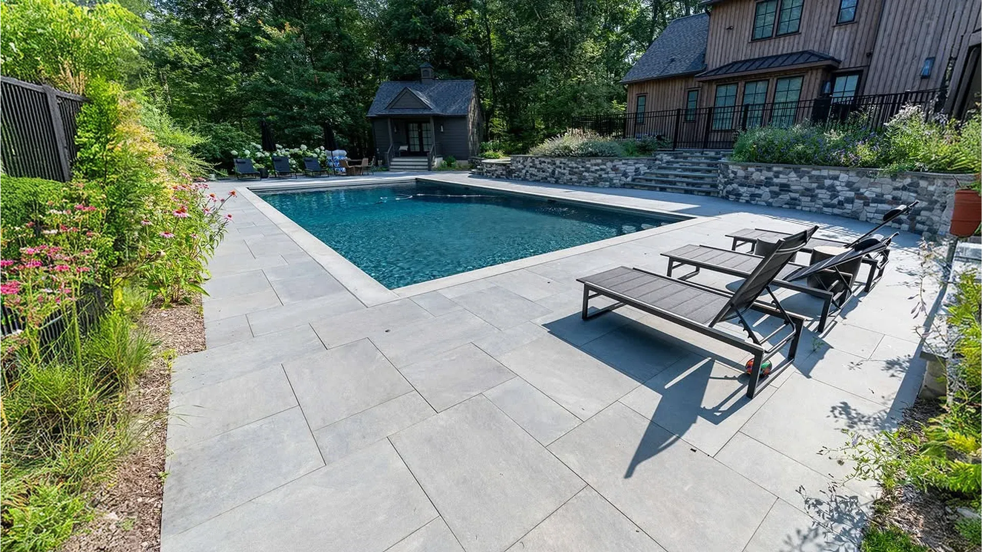 Luxury resort-style pool deck in a Lakeland, FL backyard with pavers, palm trees, and lounge chairs Luxury resort-style pool deck in a Lakeland, FL backyard with pavers, palm trees, and lounge chairs