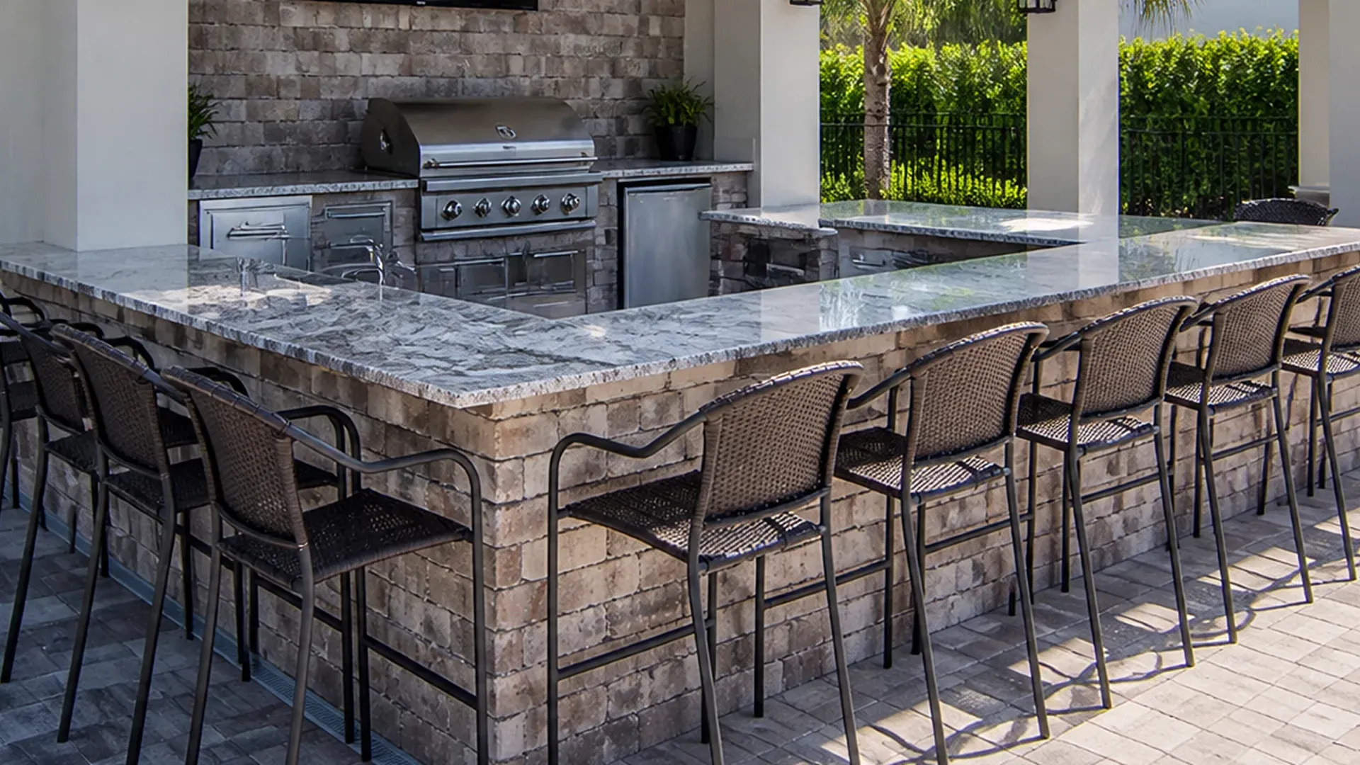 Outdoor kitchen and paver patio designed for backyard entertaining in Florida Outdoor kitchen and paver patio designed for backyard entertaining in Florida