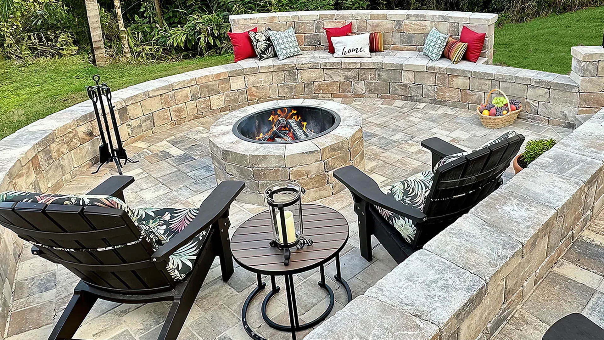 Paver patio with a fire pit creating a cozy outdoor entertaining space in Haines City Paver patio with a fire pit creating a cozy outdoor entertaining space in Haines City