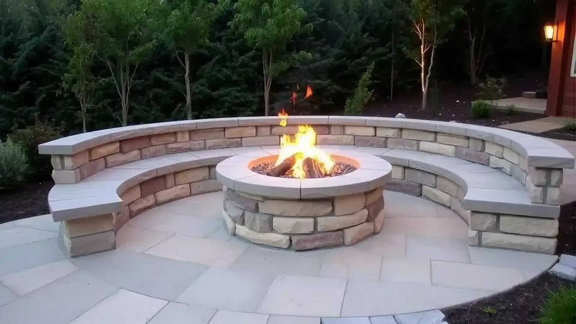 Paver fire pit with curved seating wall in a residential backyard Paver fire pit with curved seating wall in a residential backyard