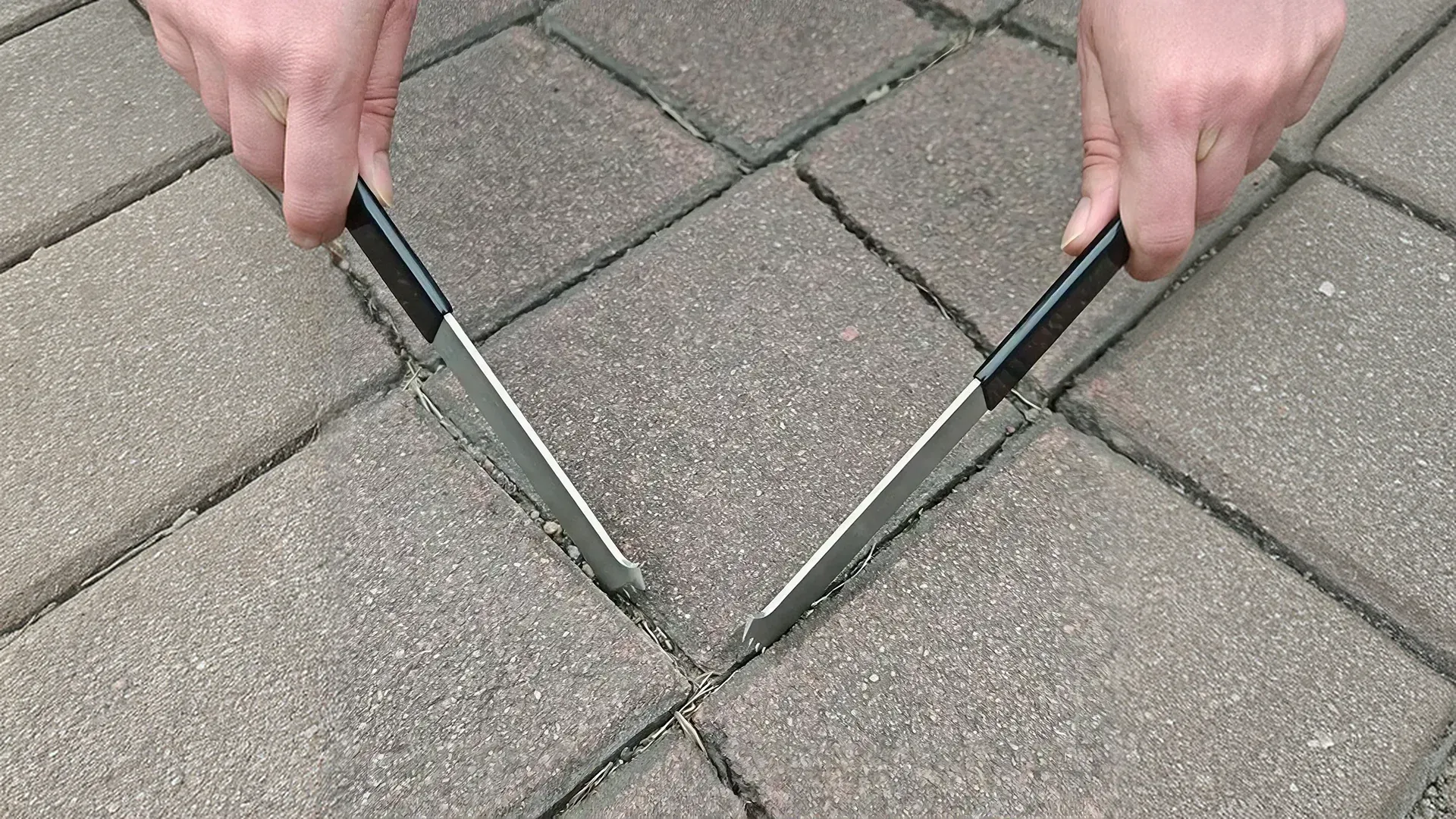 Contractor performing sunken pavers repair by removing and leveling pavers Contractor performing sunken pavers repair by removing and leveling pavers