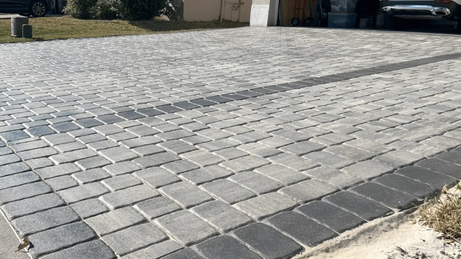 Herringbone pattern driveway pavers with a contrasting border detail