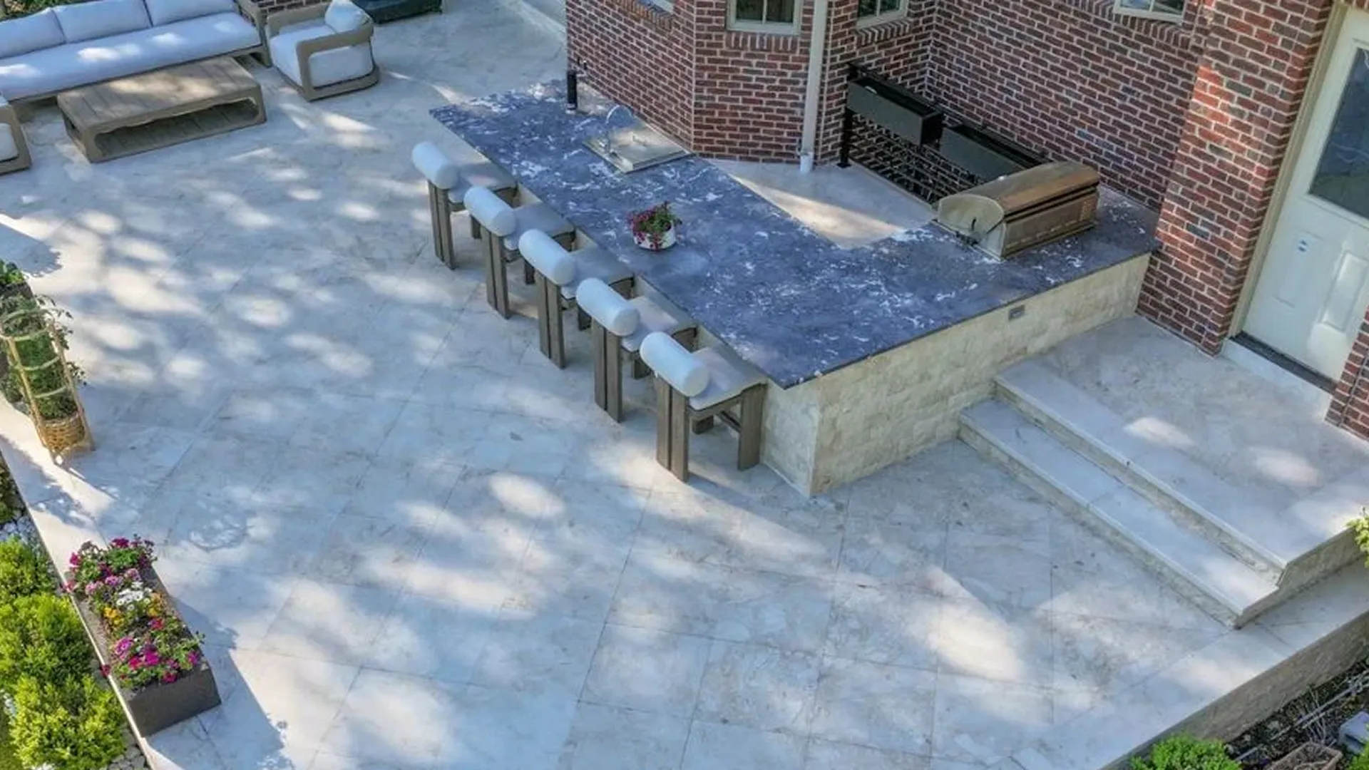 Outdoor kitchen paver surface with a porcelain contrast border
