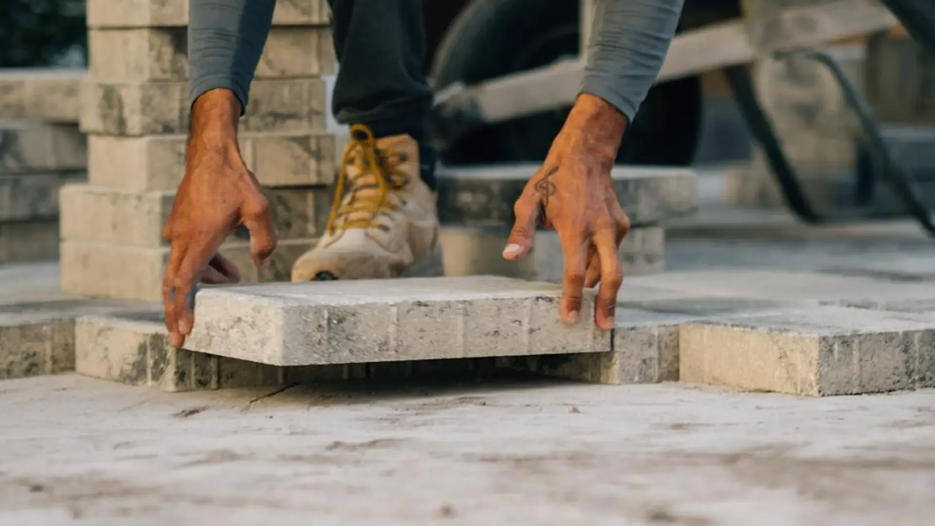 Paver walkway installation process with prepared base and newly placed pavers