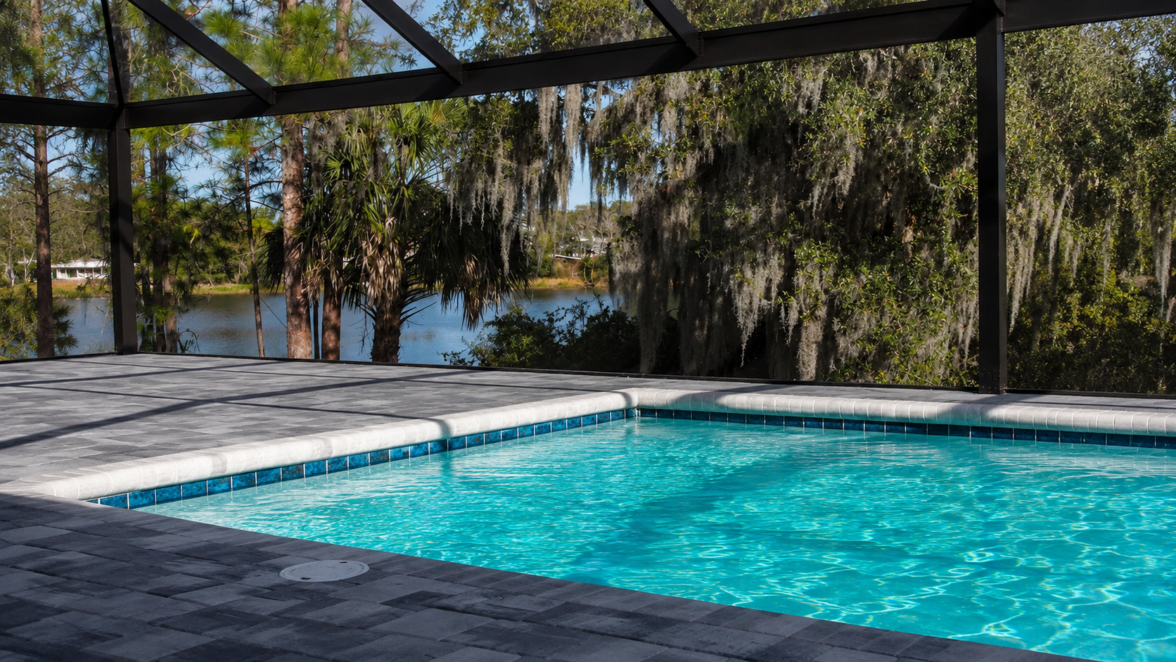 Light paver colors around a pool deck designed to stay cool in Winter Haven, FL Light paver colors around a pool deck designed to stay cool in Winter Haven, FL