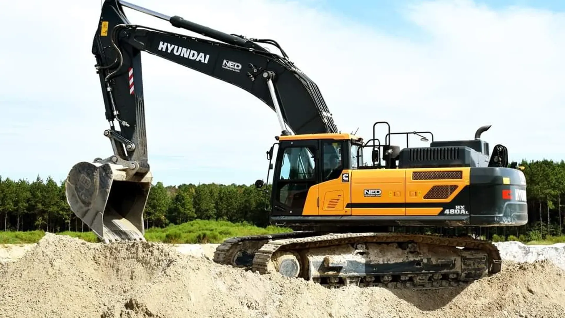 compact track loader cutting precision drainage swale in residential lawn