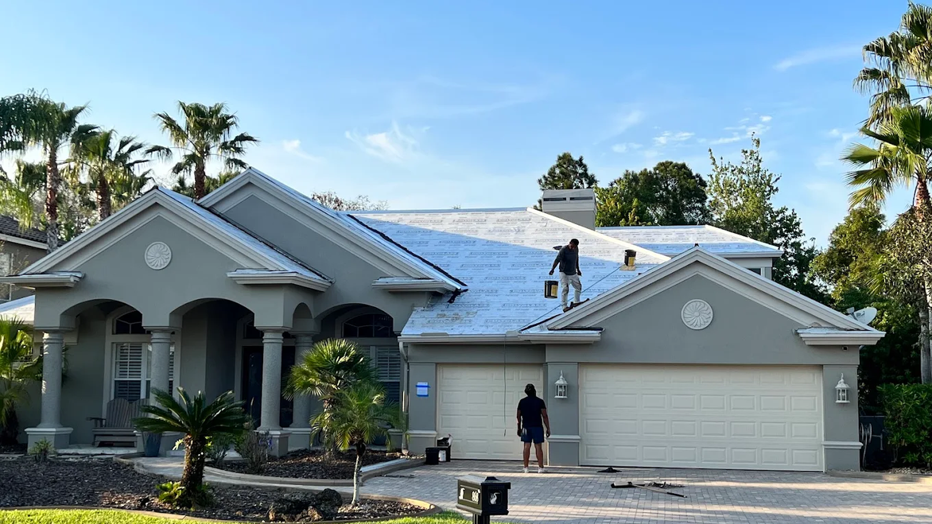 Coastal Roofing Group representative discussing a free roof consultation with a Tampa Bay homeowner Coastal Roofing Group representative discussing a free roof consultation with a Tampa Bay homeowner